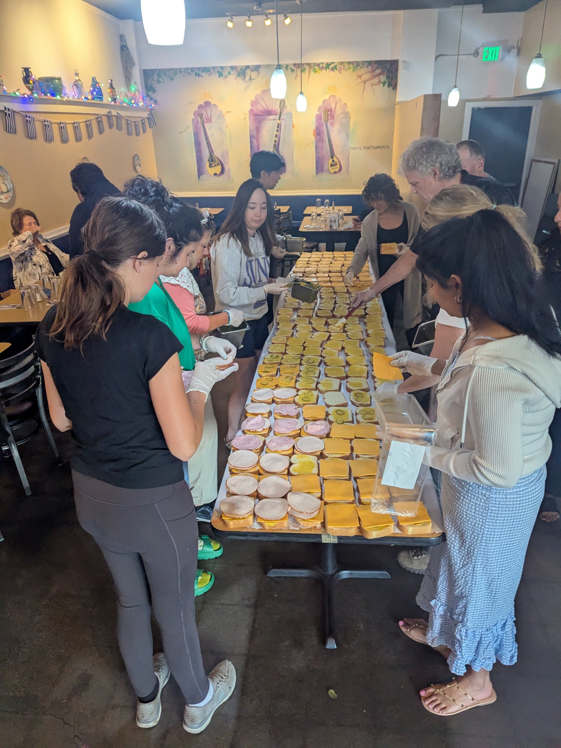 Rotarians serves community through monthly sandwich assembly